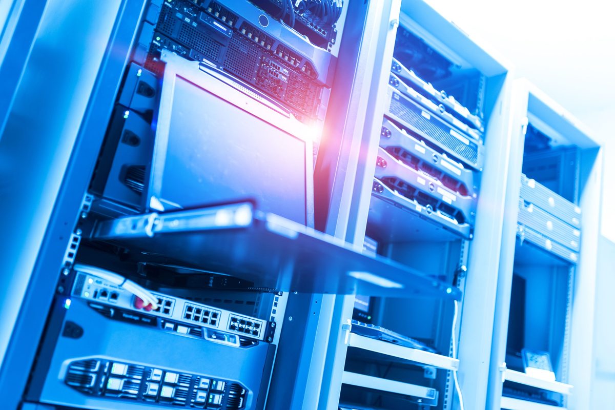 An open cabinet of rack-mounted equipment in a production data hall