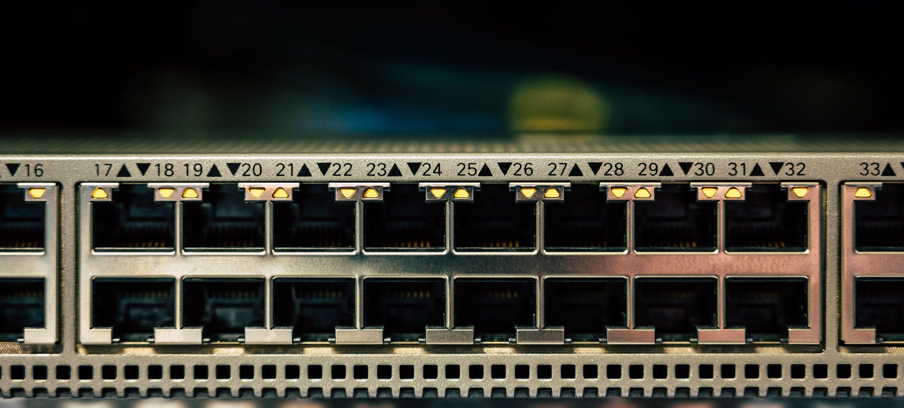 A switch faceplate with ports numbered sixteen to thirty-three, some carrying link indicators