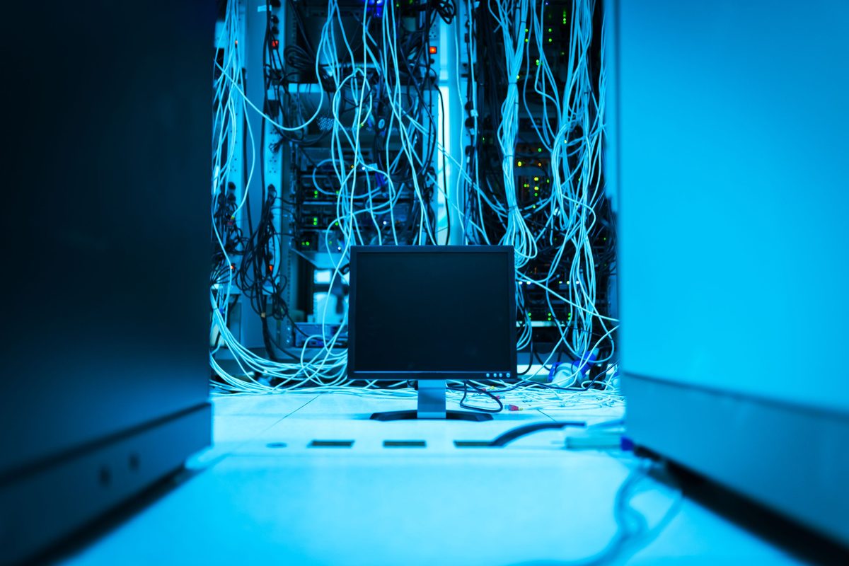 A cable run traced down the back of a cabinet row