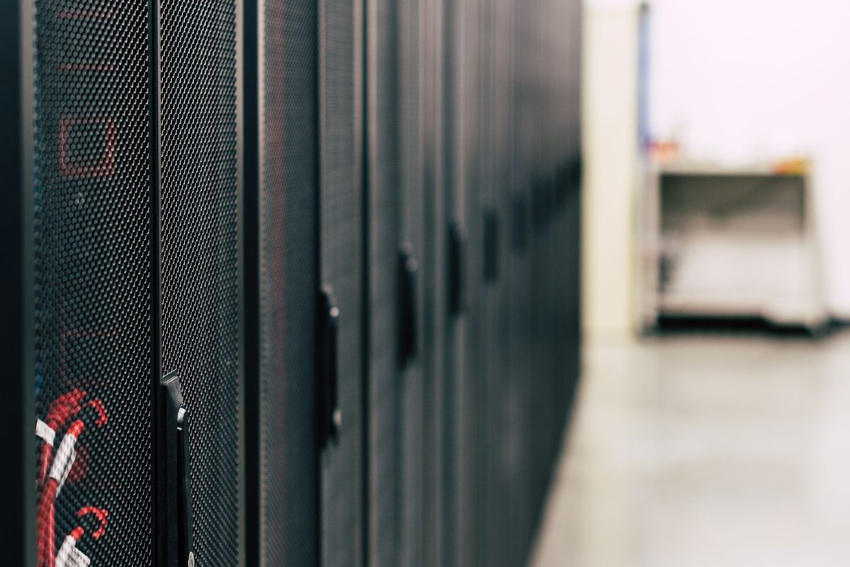 Cabinet rows seen down a secured data hall