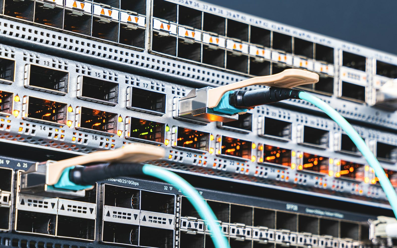 Optical transceivers and short uplink cables plugged into a switch line card