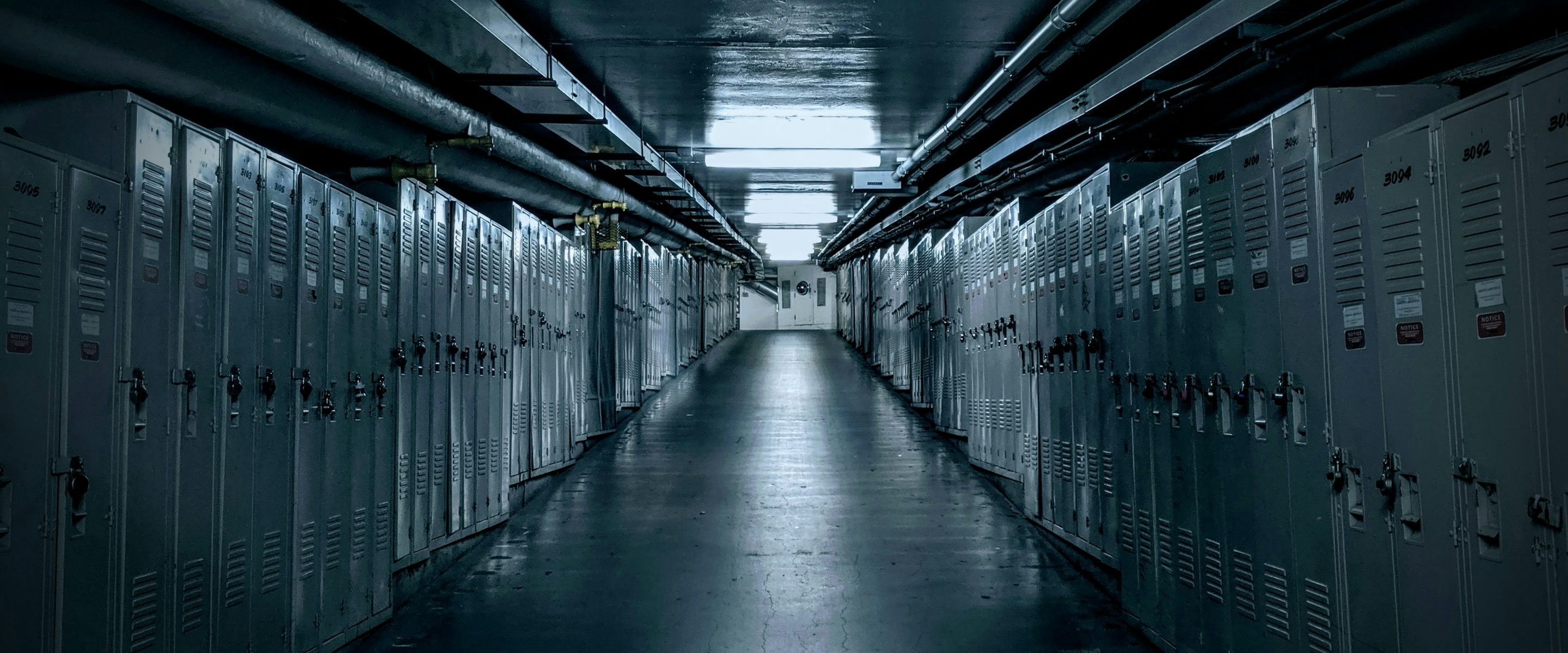 Cabinet rows seen down a secured facility corridor
