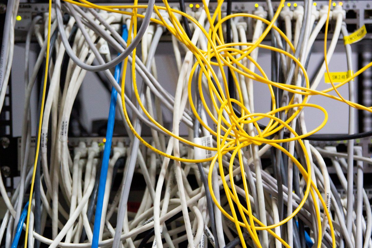 Unmapped cabling massed behind a cabinet