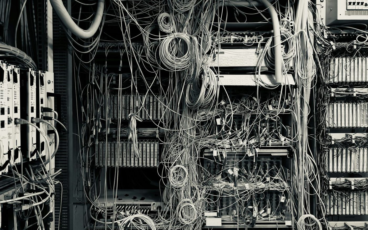 An inherited rack frame, densely cabled, during a migration assessment