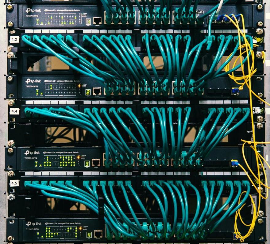 Front of a network rack with patch panels and switches, unlabelled